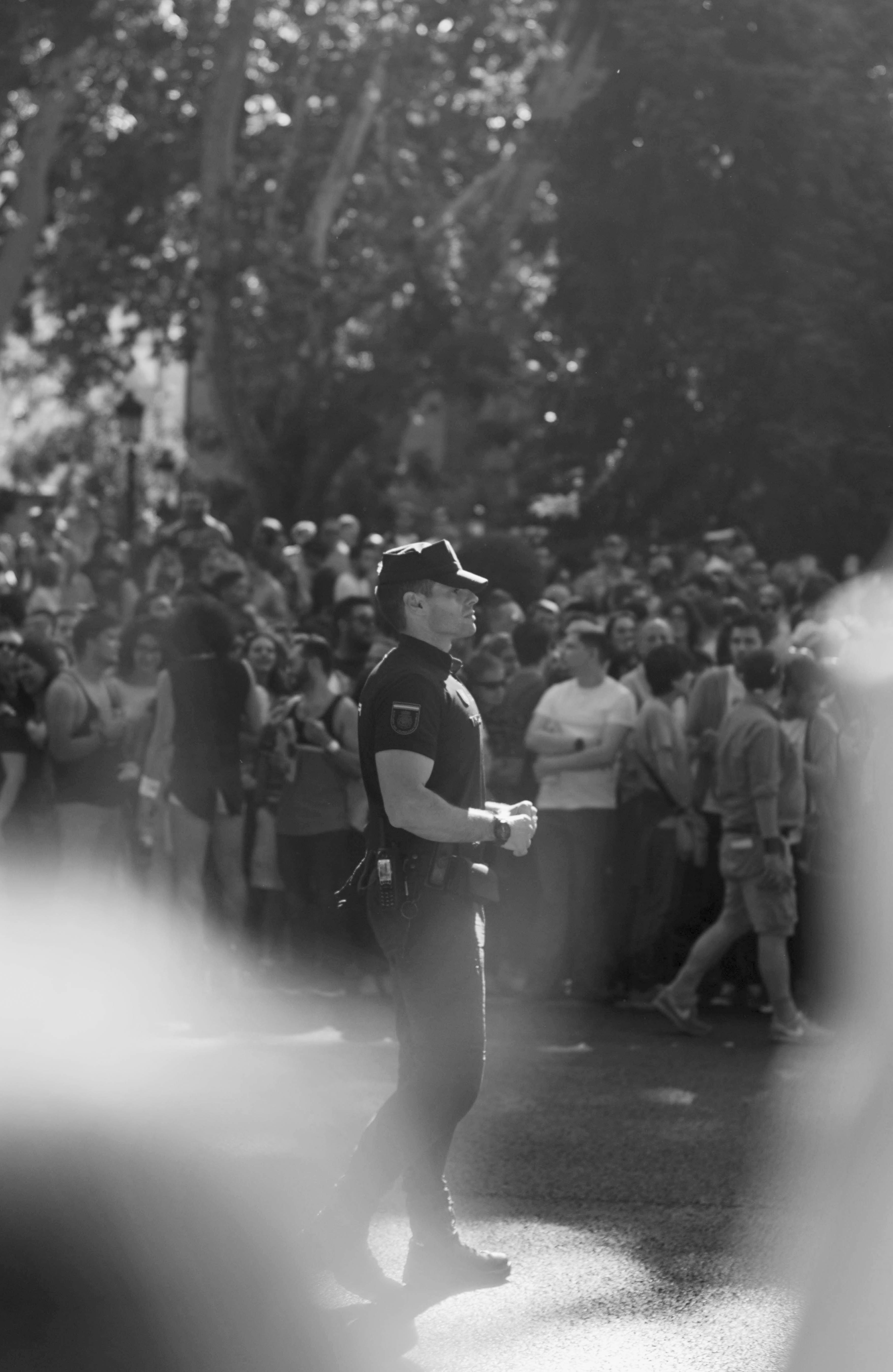 a black and white photo of a police officer in a pride parade
