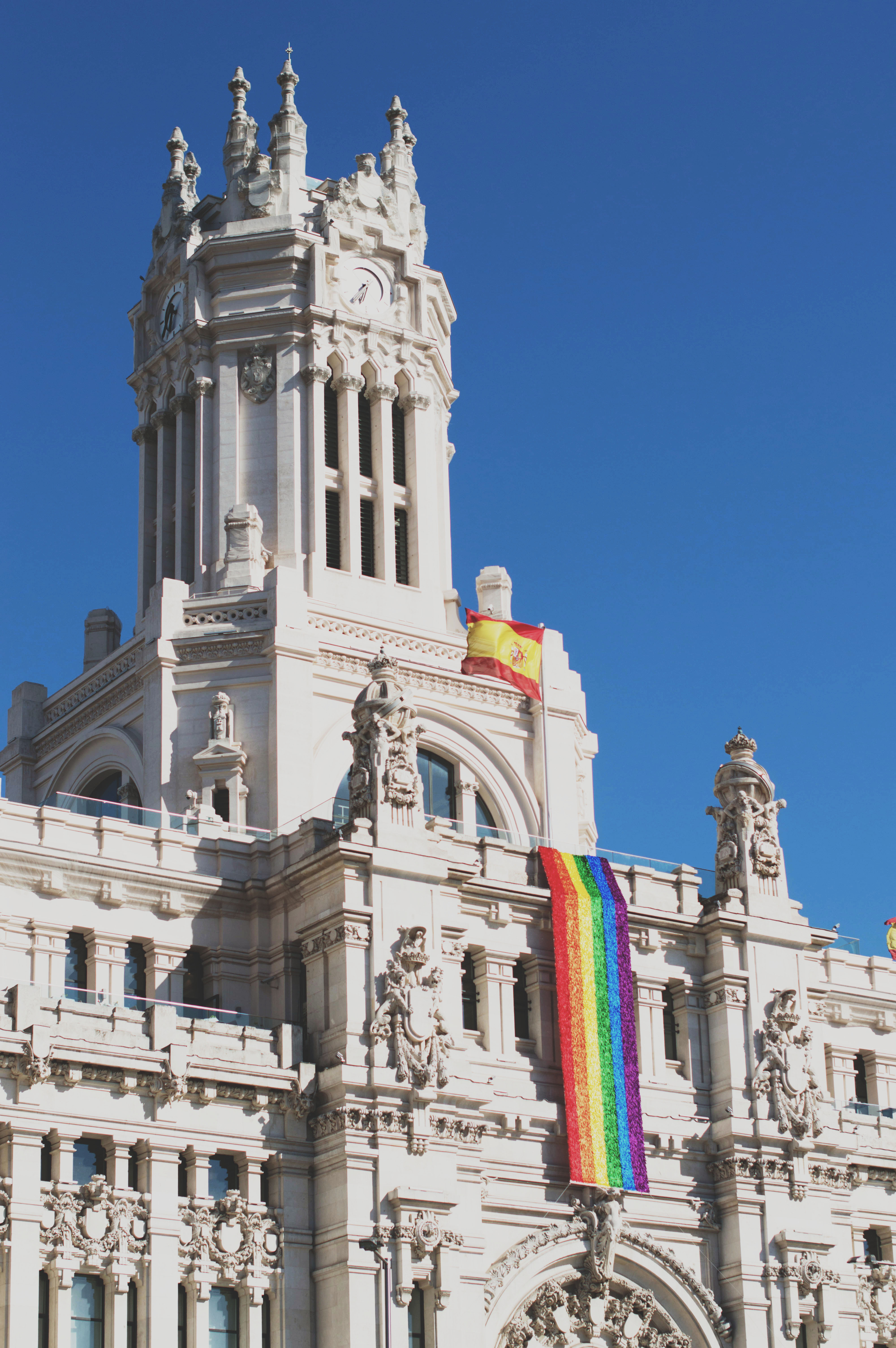 a government building in madrid adorned with a pride flag