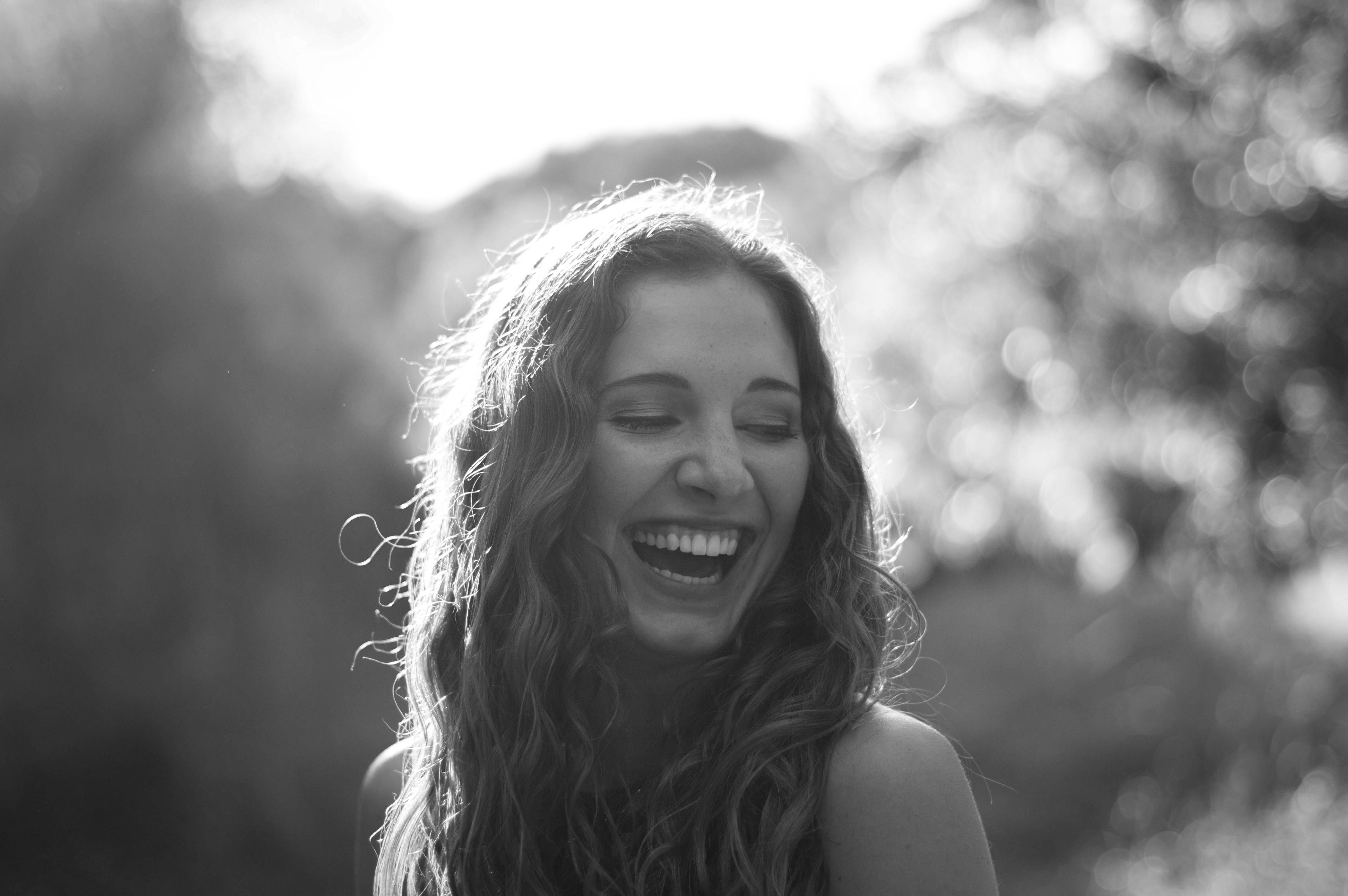 a black and white portrait of a smiling young woman
